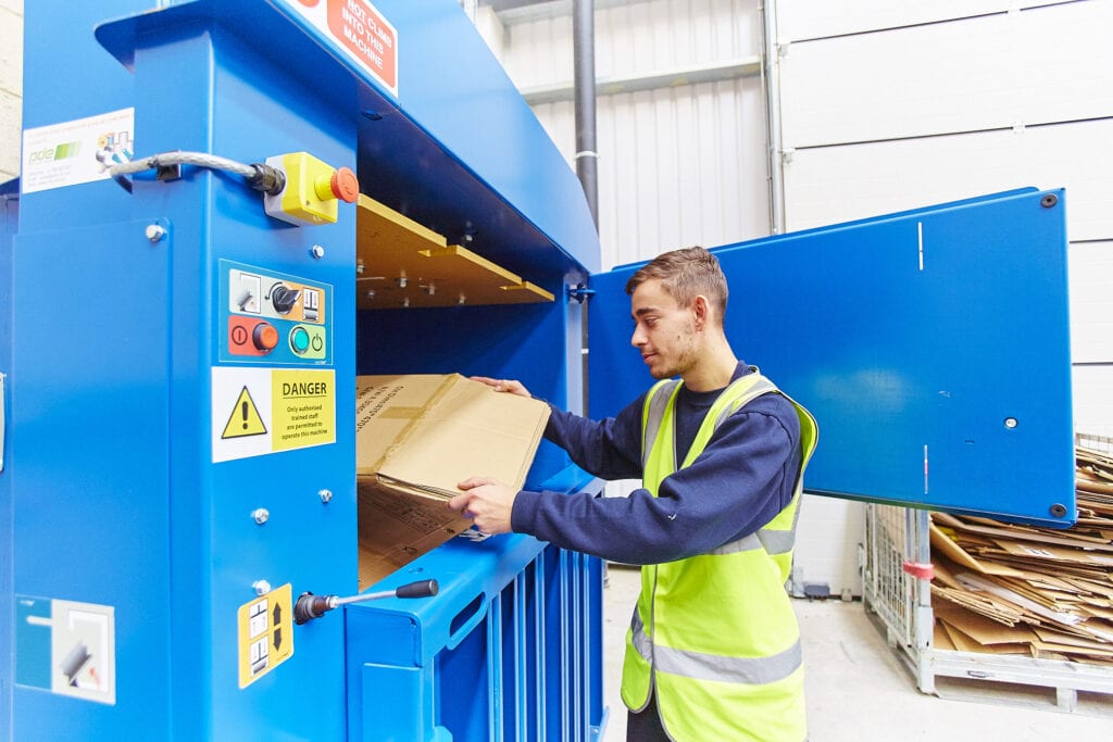 Cardboard being put into box crusher