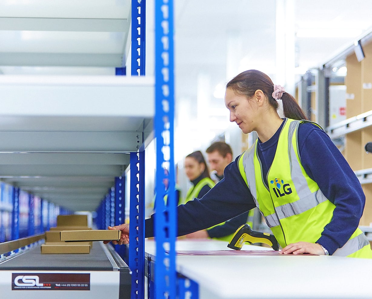 Woman sorting packages in a fulfillment warehouse